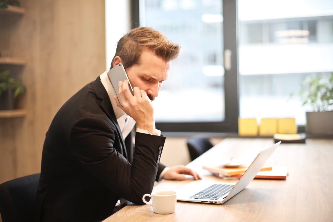 Man taking a call 9 - The Growing Costs of Software Products for Your Business's Benefit